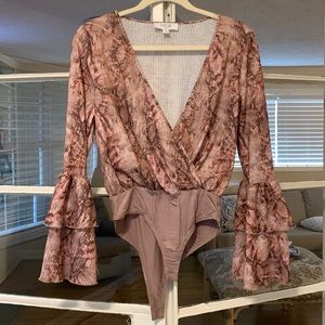 Body suit with bell sleeves.